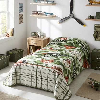 Children's bedroom with a green and white patterned bedspread, shelves with toys, and a propeller on the wall.